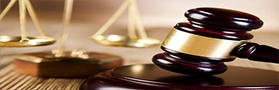 An image of Scales of Justice and a wooden gavel
